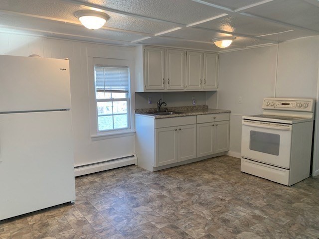 18 Taunton Street, Unit 2 Plainville, MA 02762 - Photo 4 of 15 a kitchen with stainless steel appliances granite countertop a stove a sink and a refrigerator