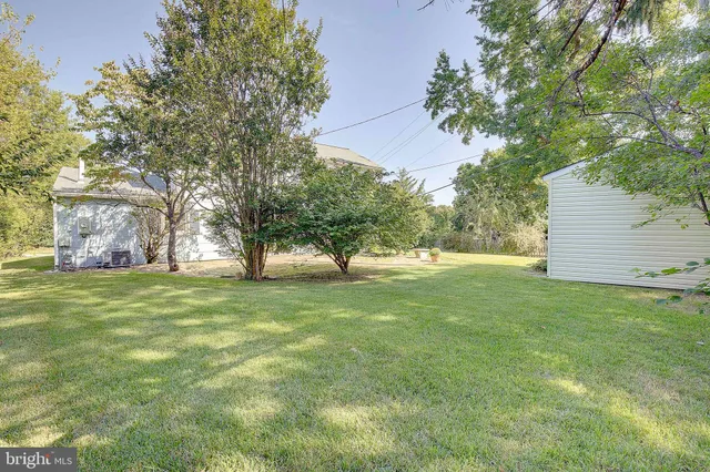 an aerial view of a house with a yard and sitting area