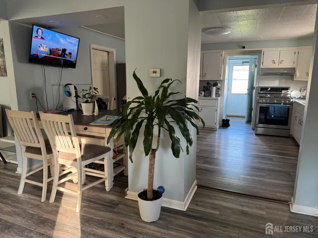 a view of a dining room with furniture and wooden floor