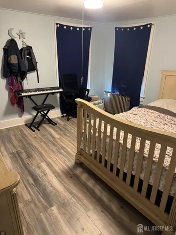 a bedroom with furniture and wooden floor