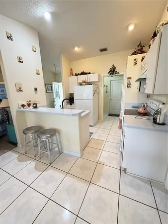 a large white kitchen with cabinets
