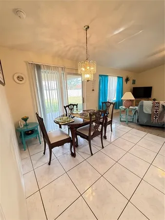 a living room with furniture a window and a chandelier