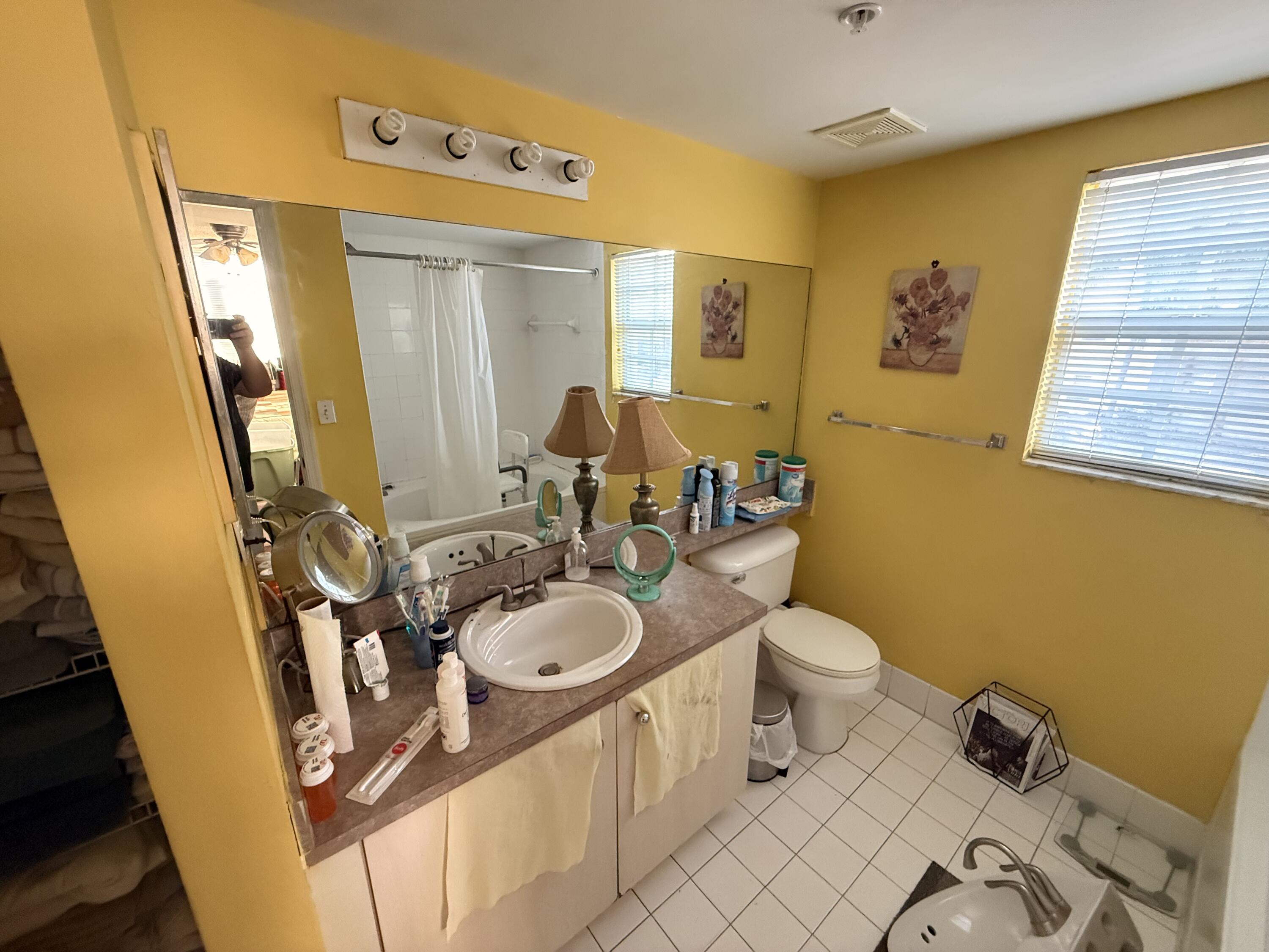 520 Southwest 111th Avenue, Unit 202 Pembroke Pines, FL 33025 - Photo 11 of 20 a bathroom with a sink a toilet and a mirror