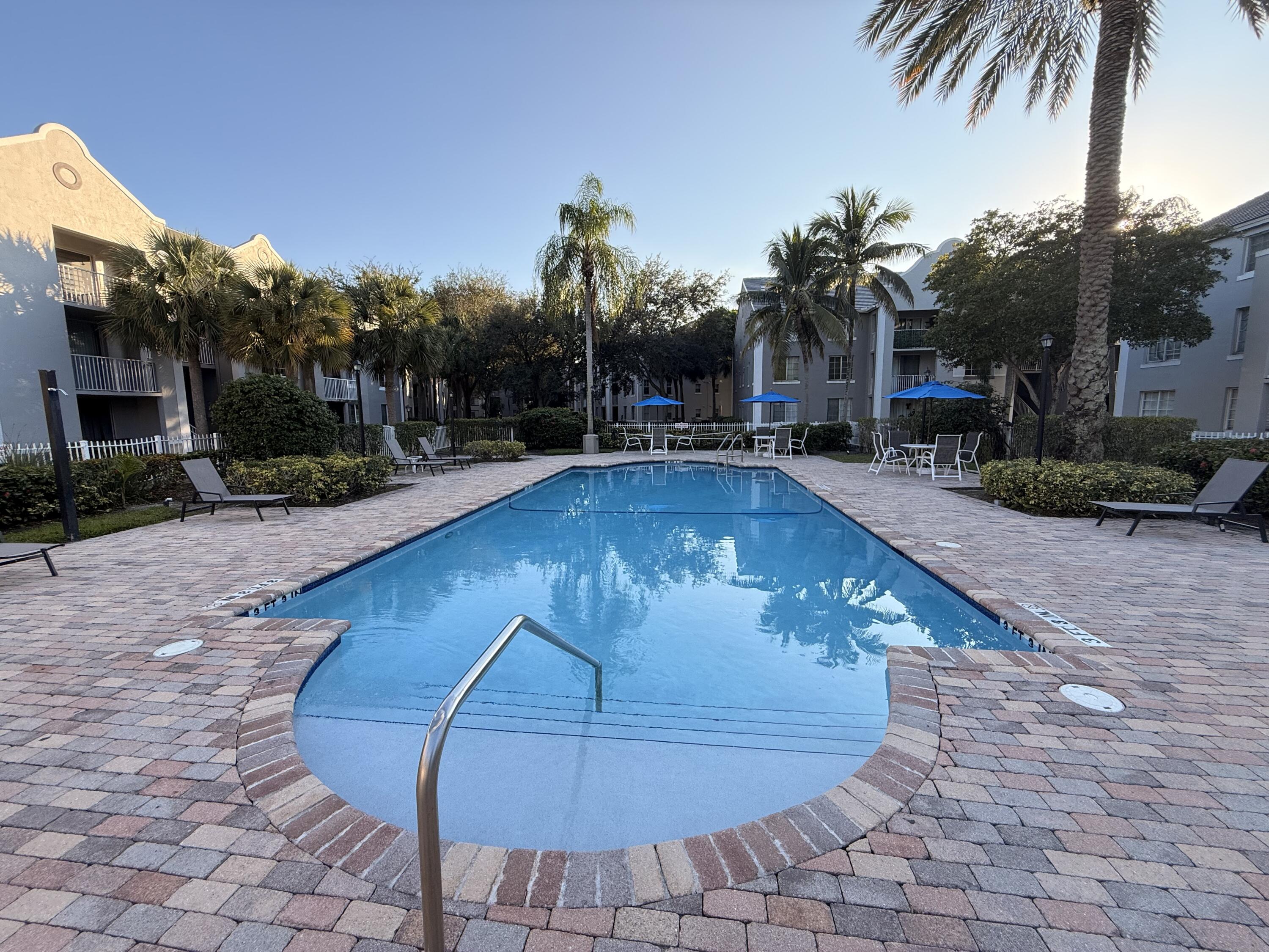 520 Southwest 111th Avenue, Unit 202 Pembroke Pines, FL 33025 - Photo 18 of 20 a view of a swimming pool with a patio