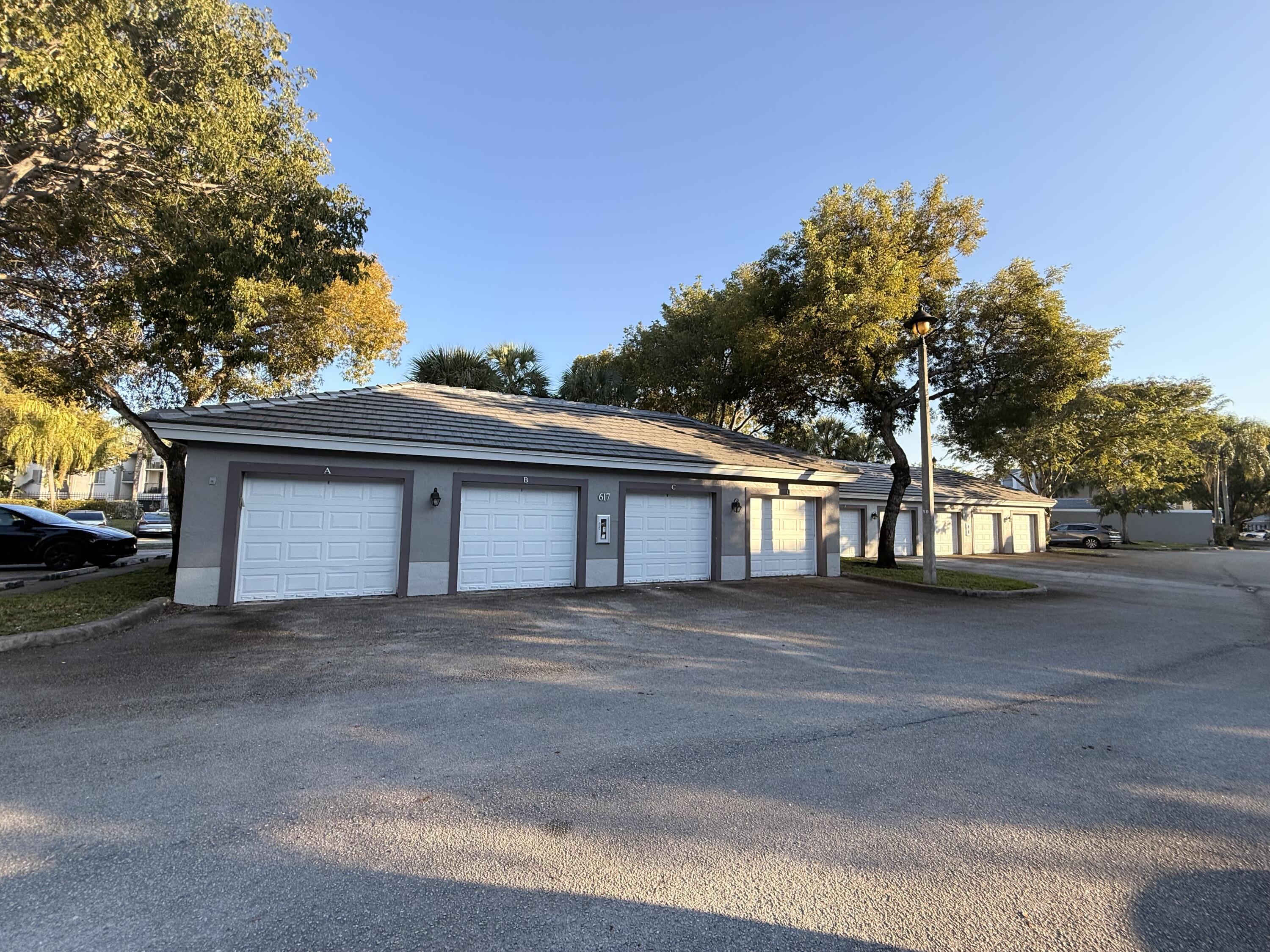 520 Southwest 111th Avenue, Unit 202 Pembroke Pines, FL 33025 - Photo 19 of 20 a front view of a house with a yard and garage