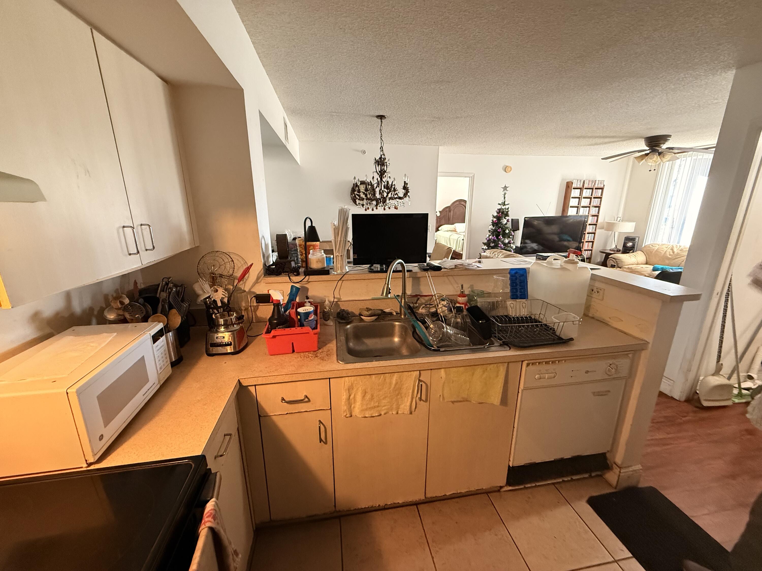 520 Southwest 111th Avenue, Unit 202 Pembroke Pines, FL 33025 - Photo 6 of 20 a room with stainless steel appliances kitchen island granite countertop a sink and cabinets