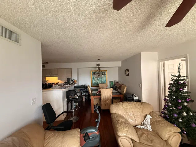 a view of a livingroom with furniture window and wooden floor