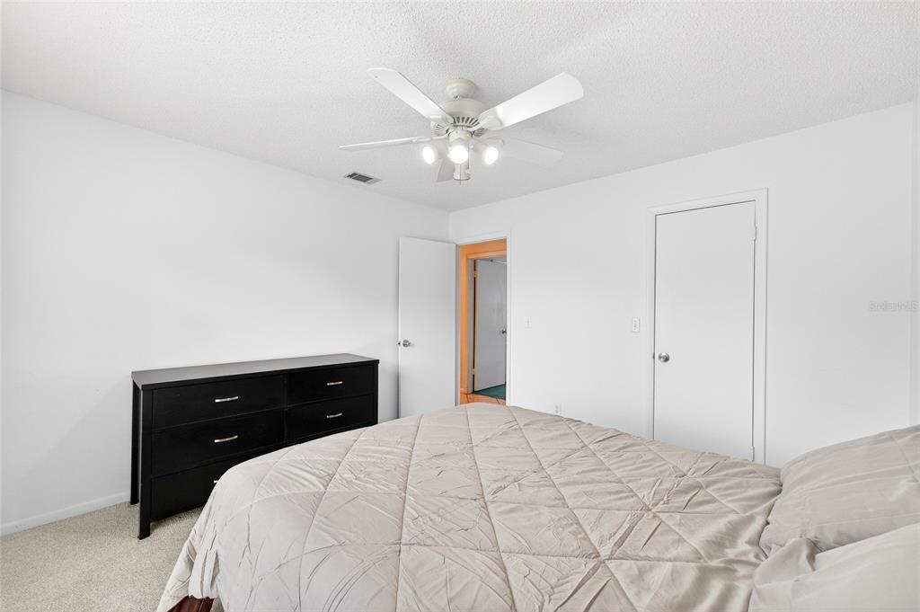 1409 Bryan Road Brandon, FL 33511 - Photo 22 of 73 a bedroom with a bed and a dresser