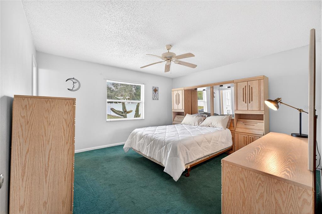 1409 Bryan Road Brandon, FL 33511 - Photo 25 of 73 a bedroom with two beds and a chandelier