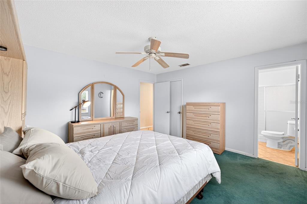 1409 Bryan Road Brandon, FL 33511 - Photo 27 of 73 a bedroom with a bed and a chandelier