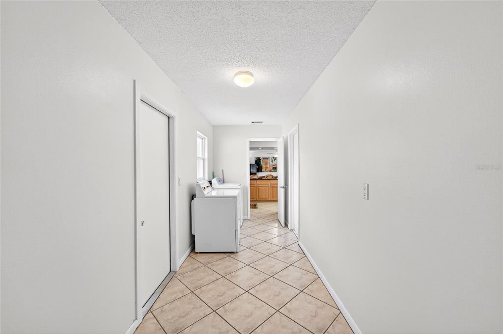 1409 Bryan Road Brandon, FL 33511 - Photo 34 of 73 a view of a kitchen with a sink and dishwasher a refrigerator with white cabinets