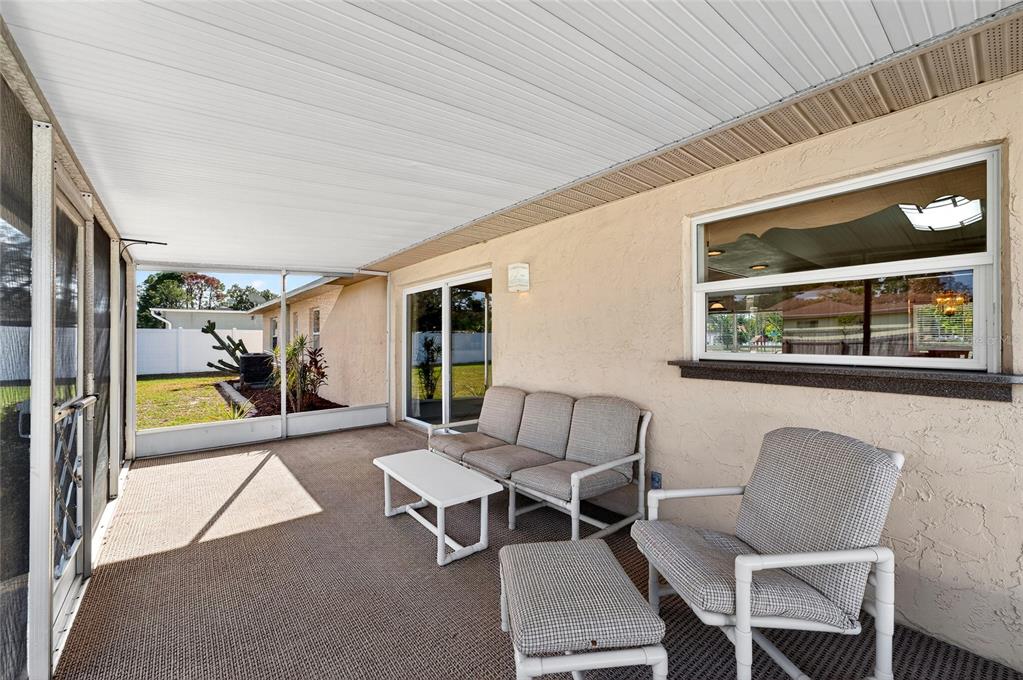1409 Bryan Road Brandon, FL 33511 - Photo 37 of 73 a living room with furniture and a floor to ceiling window