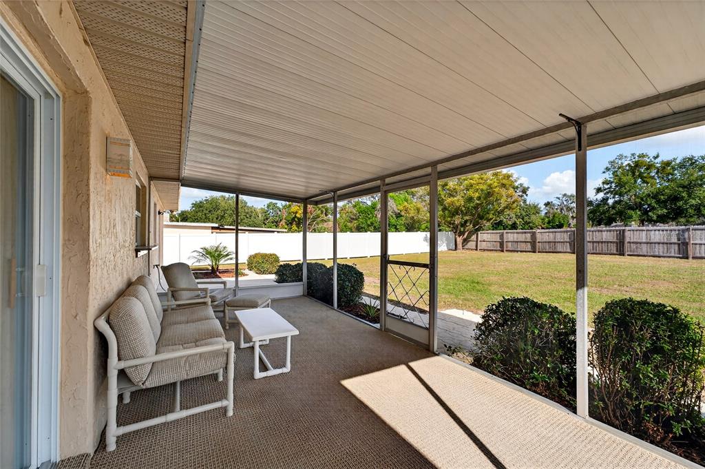 1409 Bryan Road Brandon, FL 33511 - Photo 38 of 73 a living room with hardwood floor and a floor to ceiling window