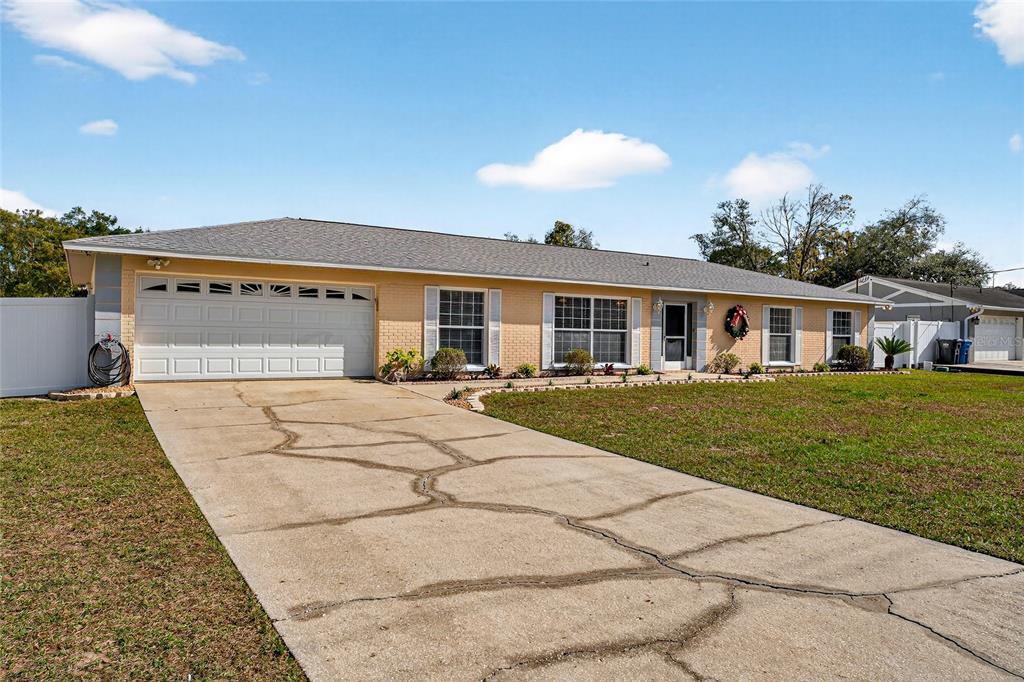 1409 Bryan Road Brandon, FL 33511 - Photo 40 of 73 a front view of a house with a yard and potted plants