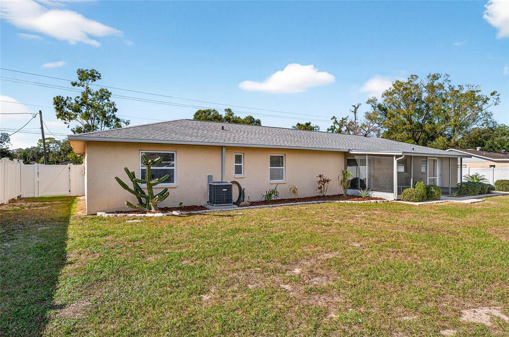 1409 Bryan Road Brandon, FL 33511 - Photo 46 of 73 a view of a house with a yard and potted plants