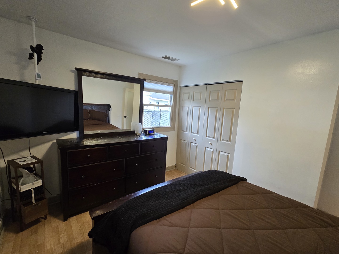 14932 Kedvale Avenue Midlothian, IL 60445 - Photo 8 of 17 a bedroom with a bed and a flat tv screen on dresser