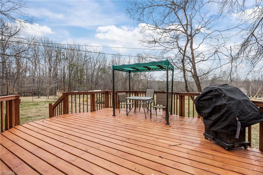 Wood deck overlooking the huge backyard of the home.