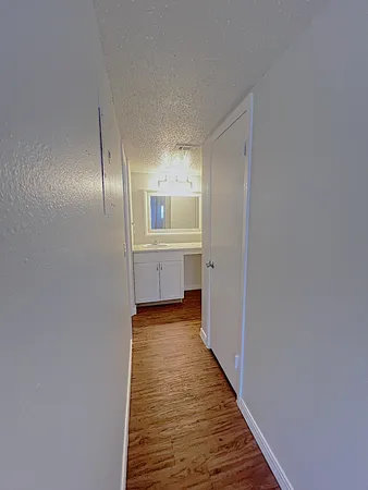 a view of a hallway with wooden floor