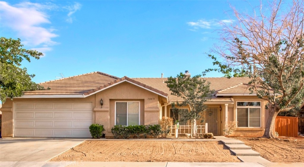 14471 Ponderosa Ranch Road Victorville, CA 92392 - Photo 1 of 1 a front view of a house with garden