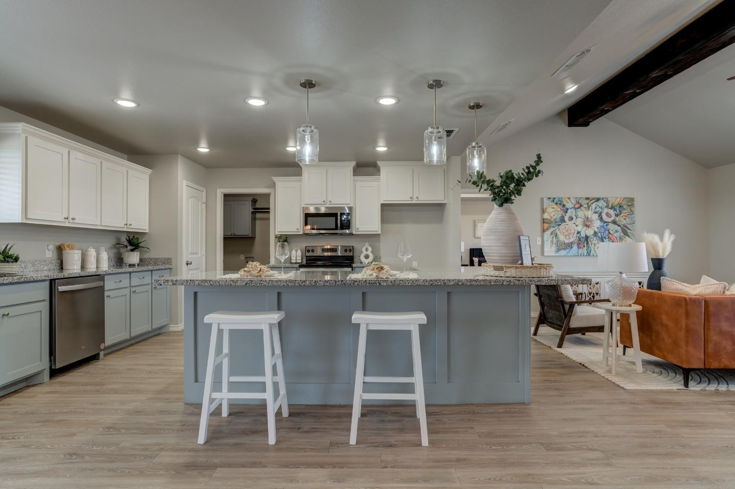 9013 County Road 6100 Shallowater, TX 79363 - Photo 15 of 49 a kitchen with a sink cabinets and wooden floor