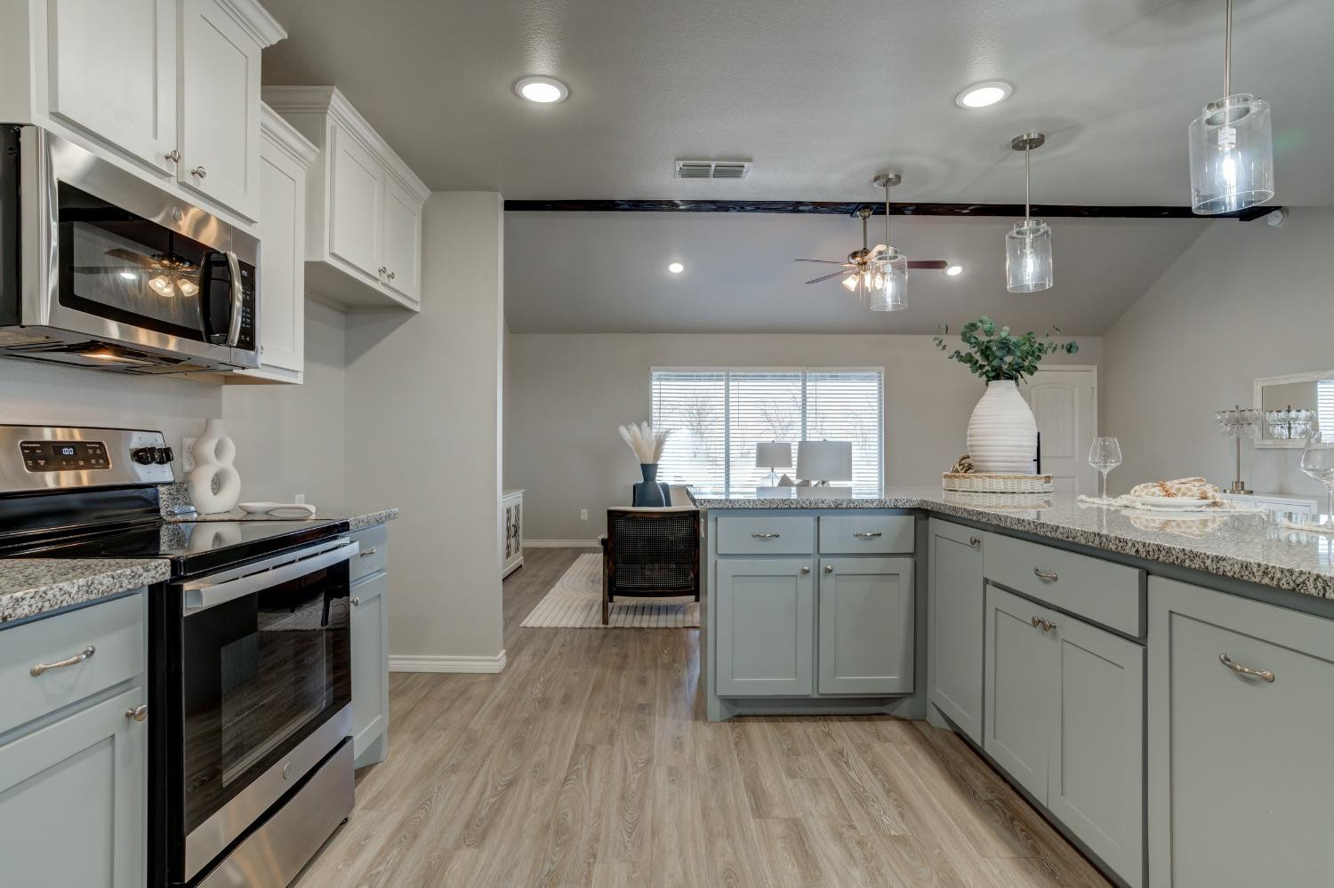 9013 County Road 6100 Shallowater, TX 79363 - Photo 17 of 49 a kitchen with kitchen island granite countertop stainless steel appliances stove microwave and cabinets