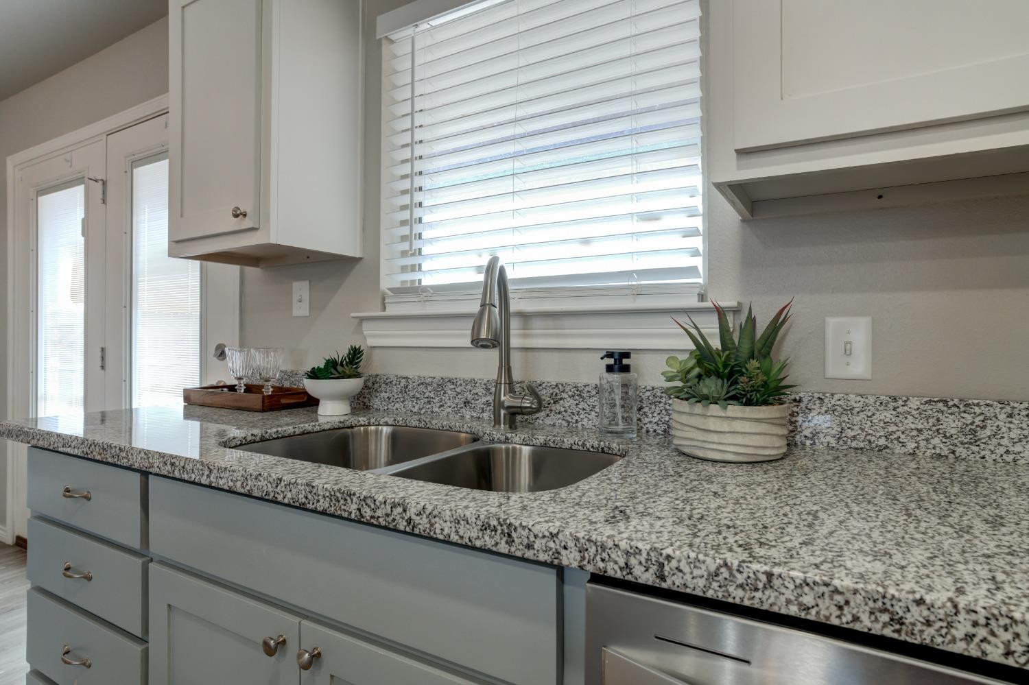 9013 County Road 6100 Shallowater, TX 79363 - Photo 18 of 49 a kitchen with sink and potted plant