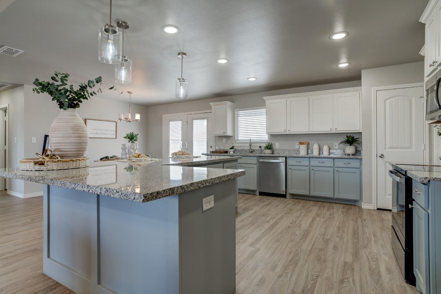 9013 County Road 6100 Shallowater, TX 79363 - Photo 20 of 49 a kitchen with kitchen island granite countertop a sink cabinets and wooden floor