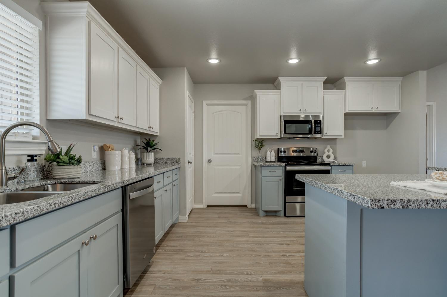 9013 County Road 6100 Shallowater, TX 79363 - Photo 24 of 49 a kitchen with kitchen island granite countertop a sink stainless steel appliances and cabinets
