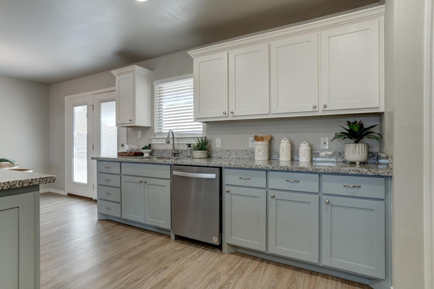 9013 County Road 6100 Shallowater, TX 79363 - Photo 25 of 49 a kitchen with granite countertop white cabinets and a stove