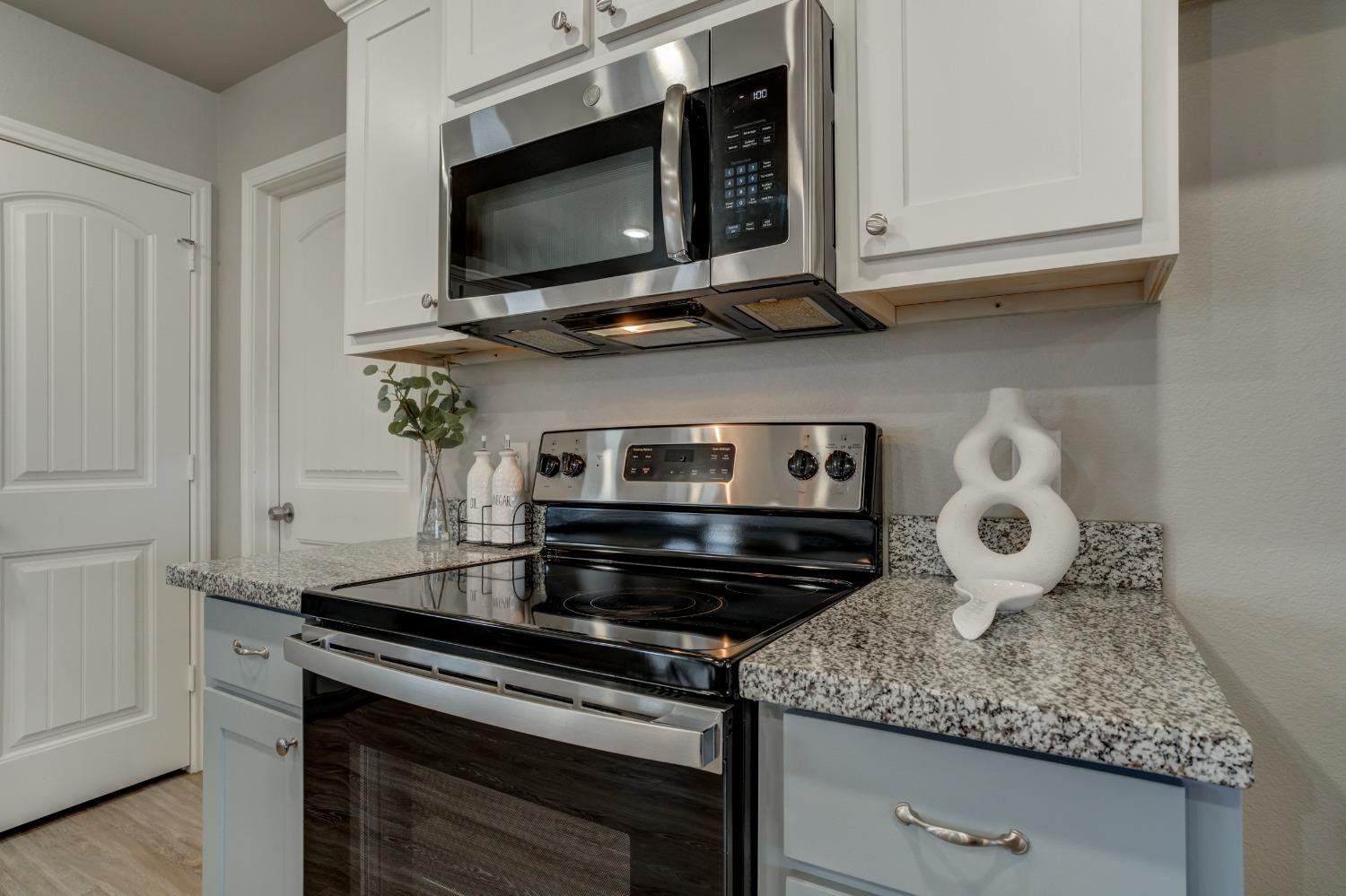 9013 County Road 6100 Shallowater, TX 79363 - Photo 26 of 49 a kitchen with stainless steel appliances granite countertop a stove and a microwave