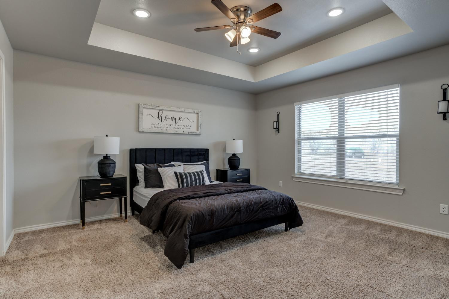 9013 County Road 6100 Shallowater, TX 79363 - Photo 29 of 49 a spacious bedroom with a bed and a chandelier