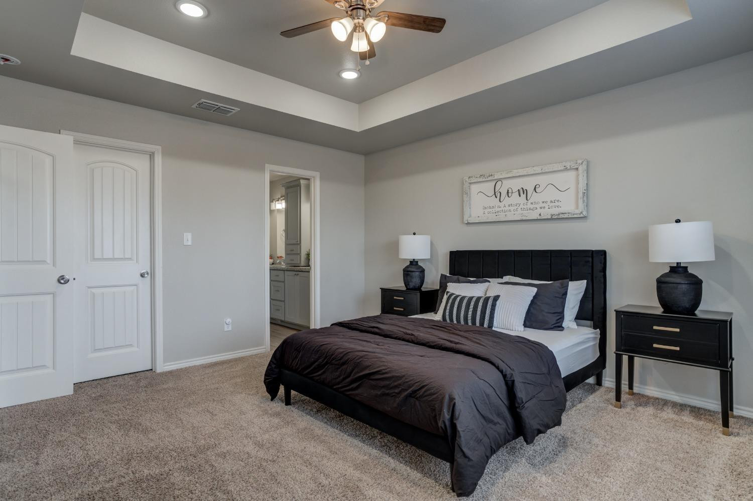 9013 County Road 6100 Shallowater, TX 79363 - Photo 30 of 49 a spacious bedroom with a bed and a chandelier