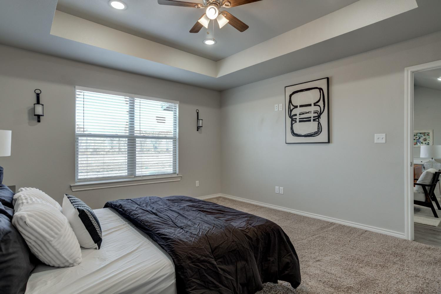 9013 County Road 6100 Shallowater, TX 79363 - Photo 32 of 49 a bedroom with a bed and a chandelier