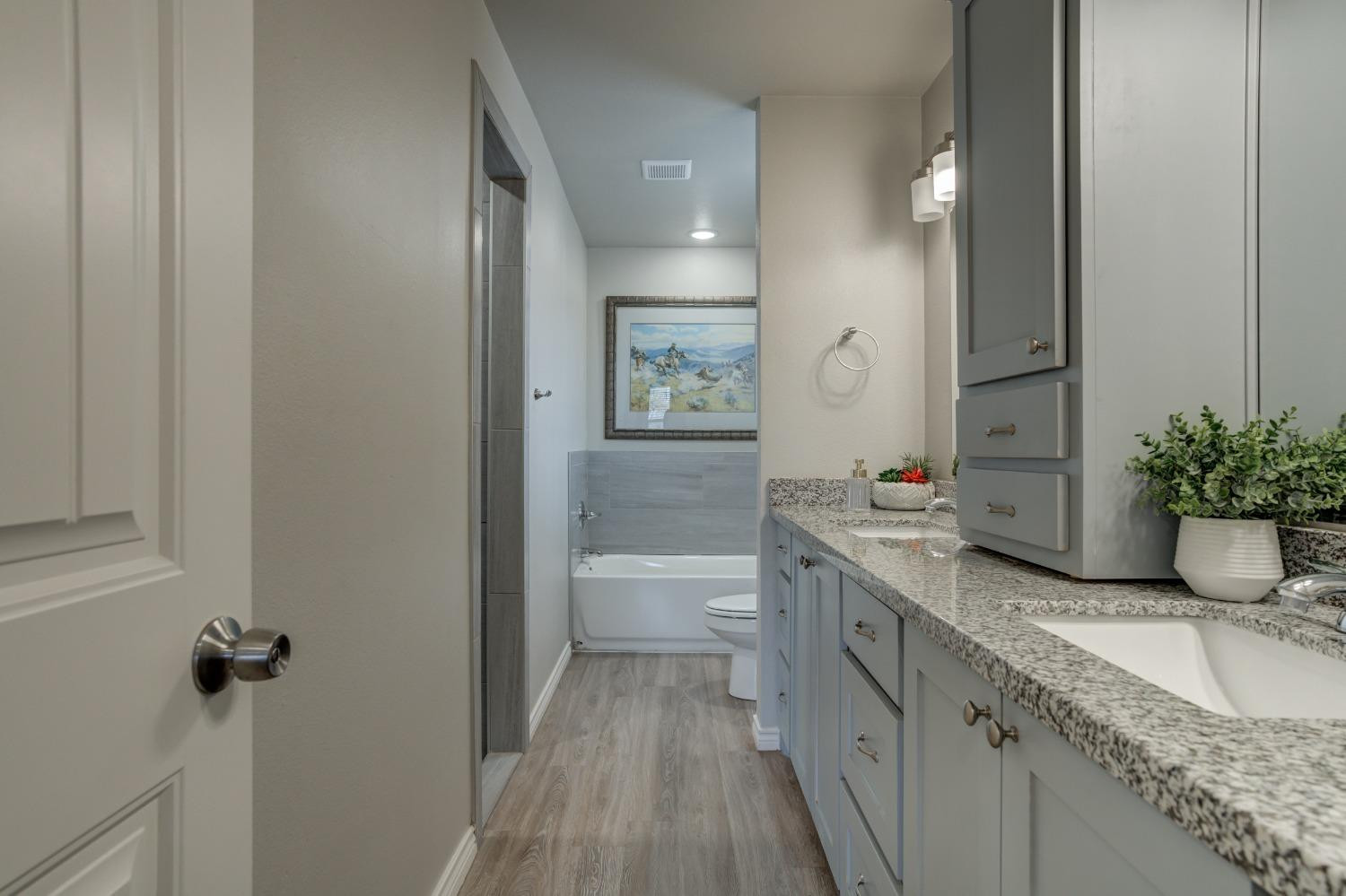 9013 County Road 6100 Shallowater, TX 79363 - Photo 33 of 49 a spacious bathroom with a granite countertop sink a toilet a mirror and shower