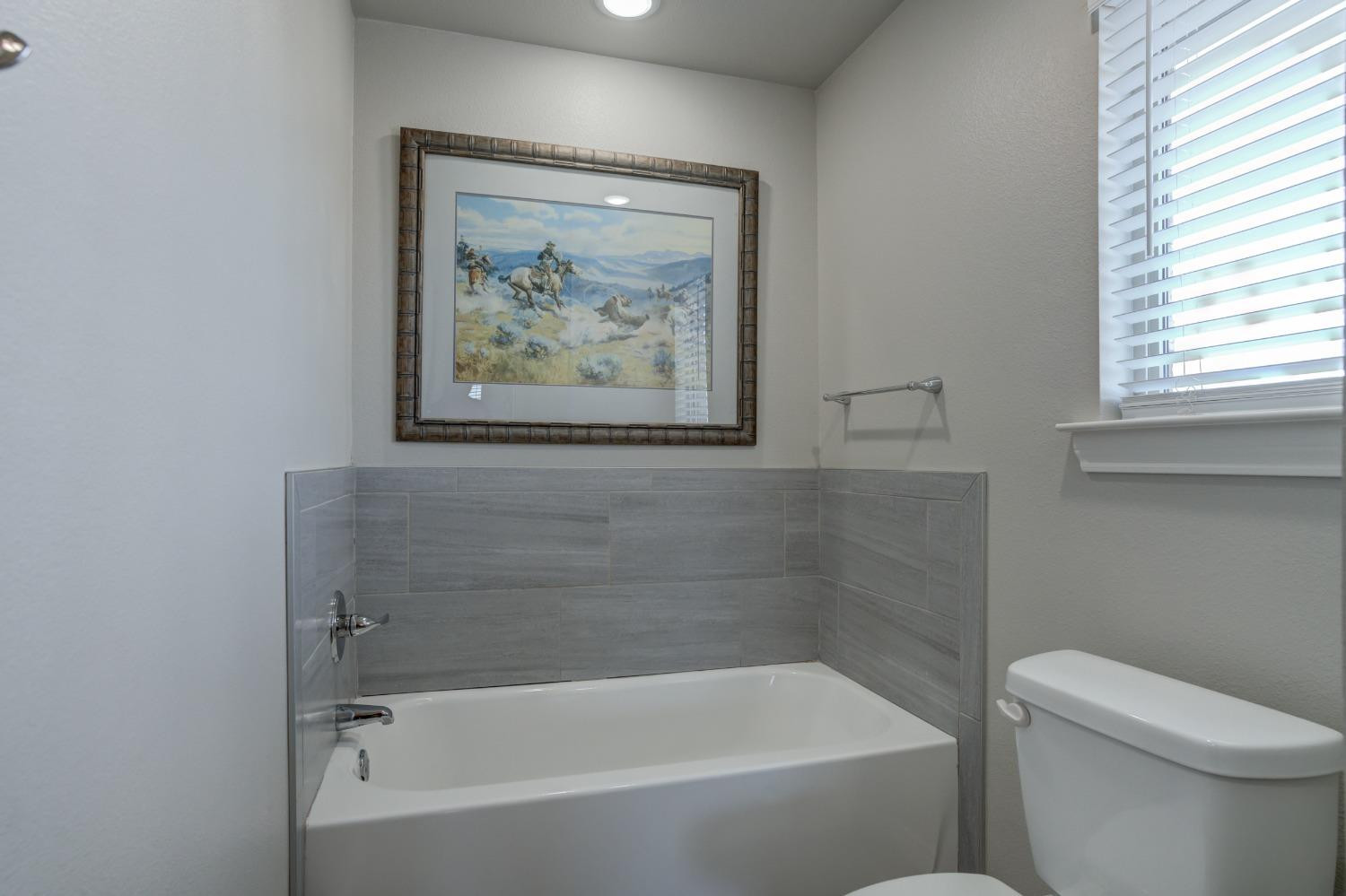 9013 County Road 6100 Shallowater, TX 79363 - Photo 35 of 49 a white bath tub sitting next to a white toilet