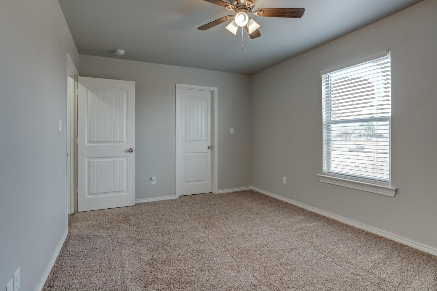 9013 County Road 6100 Shallowater, TX 79363 - Photo 41 of 49 an empty room with chandelier fan and windows