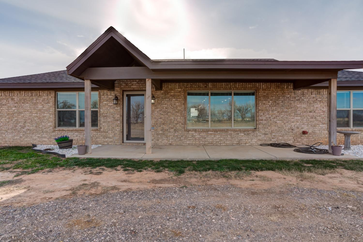 9013 County Road 6100 Shallowater, TX 79363 - Photo 5 of 49 a front view of a house with garden