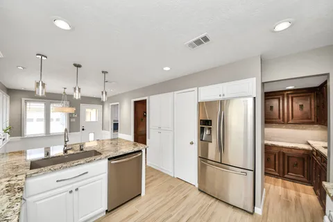view of kitchen with granite countertop cabinets and sink
