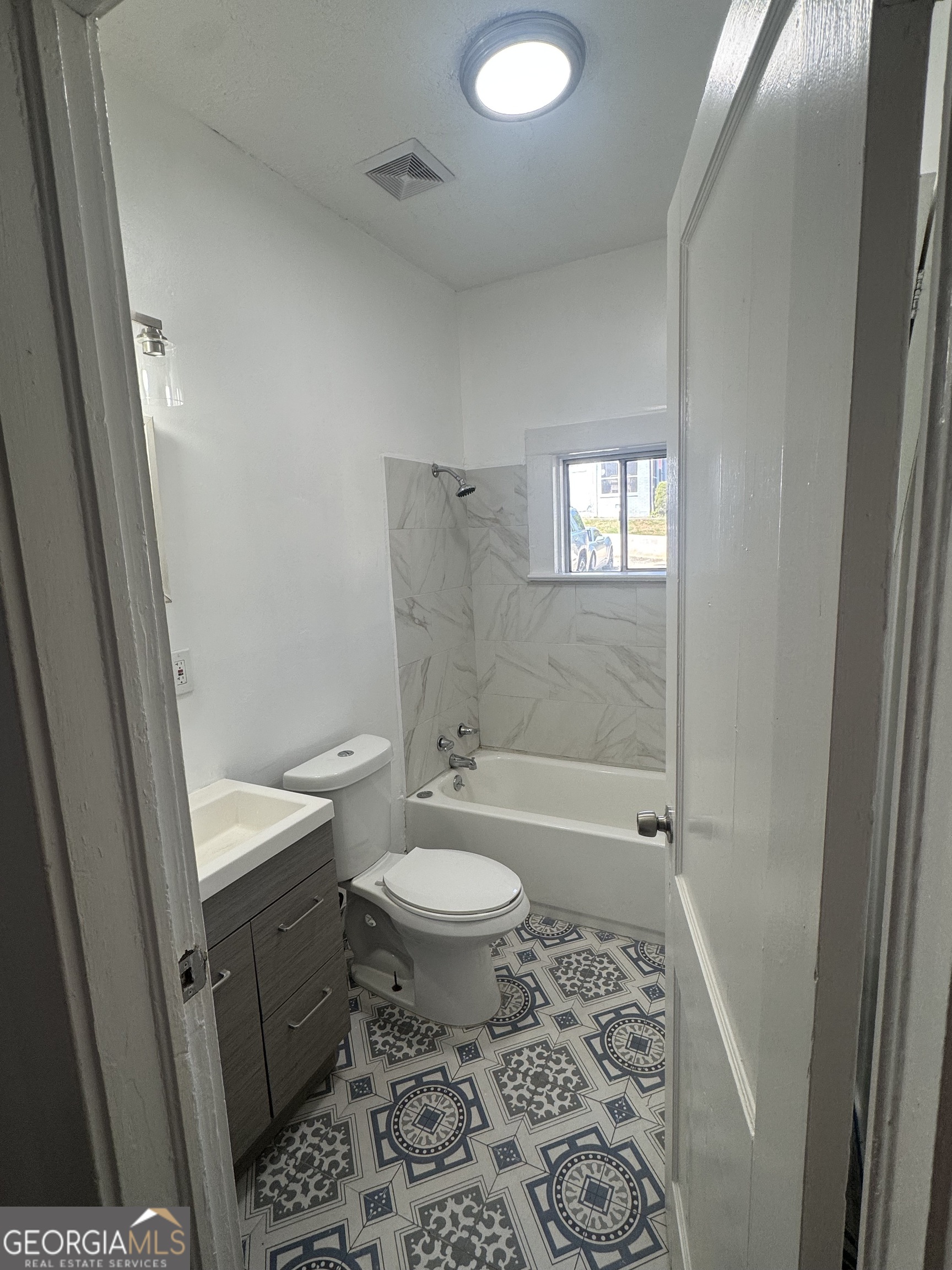 415 Hopkins Street Southwest Atlanta, GA 30310 - Photo 1 of 12 a bathroom with a granite countertop toilet a sink and a shower