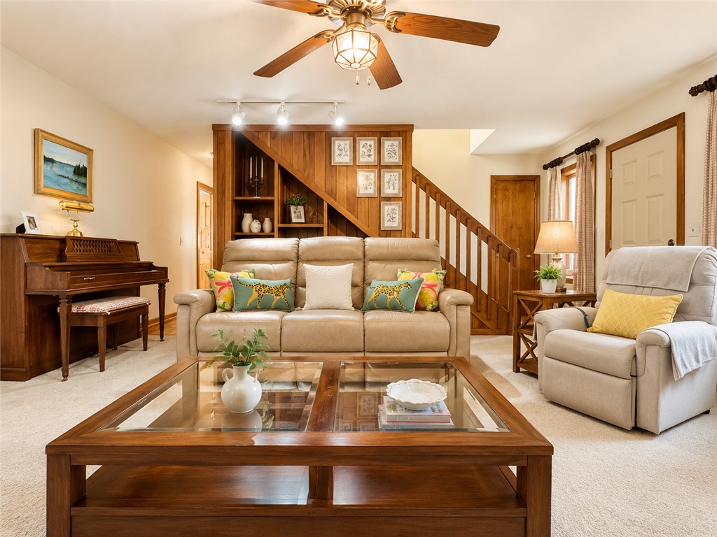 222 Terrace Drive Anderson, SC 29621 - Photo 8 of 37 A welcoming living area showcases plush carpeting and a warm wooden staircase.