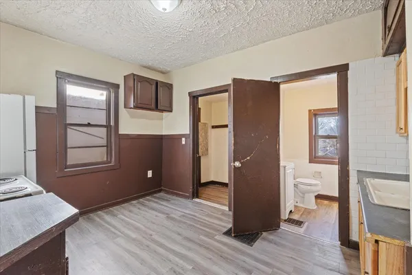 a view of a livingroom with wooden floor and staircase