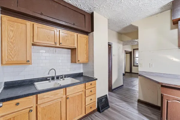a kitchen with stainless steel appliances granite countertop a sink and cabinets