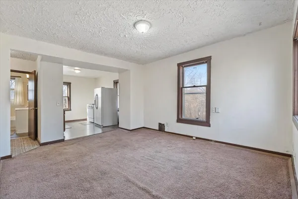 an empty room with windows and closet