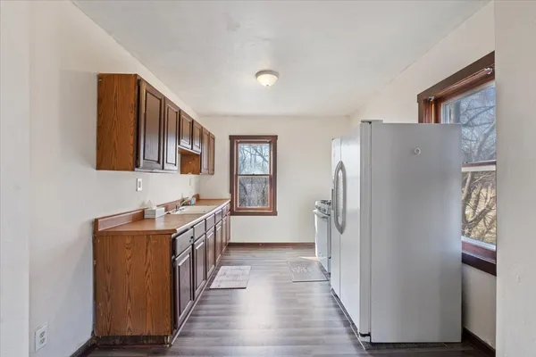 a kitchen with stainless steel appliances granite countertop a refrigerator and a sink