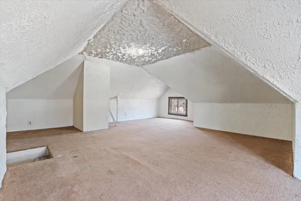 a view of a livingroom with an empty space and chandelier