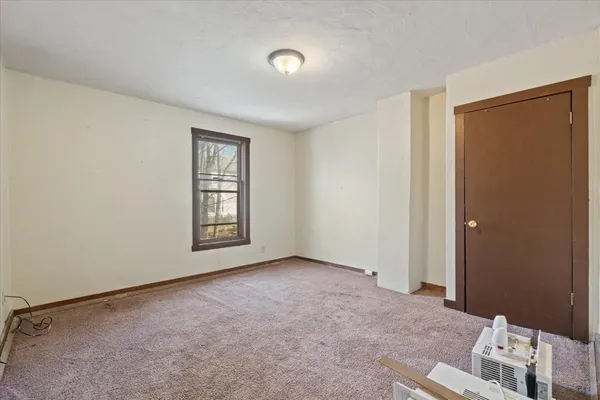 an empty room with windows and closet