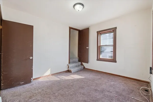 an empty room with windows and closet