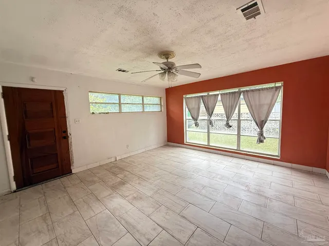 an empty room with windows and closet