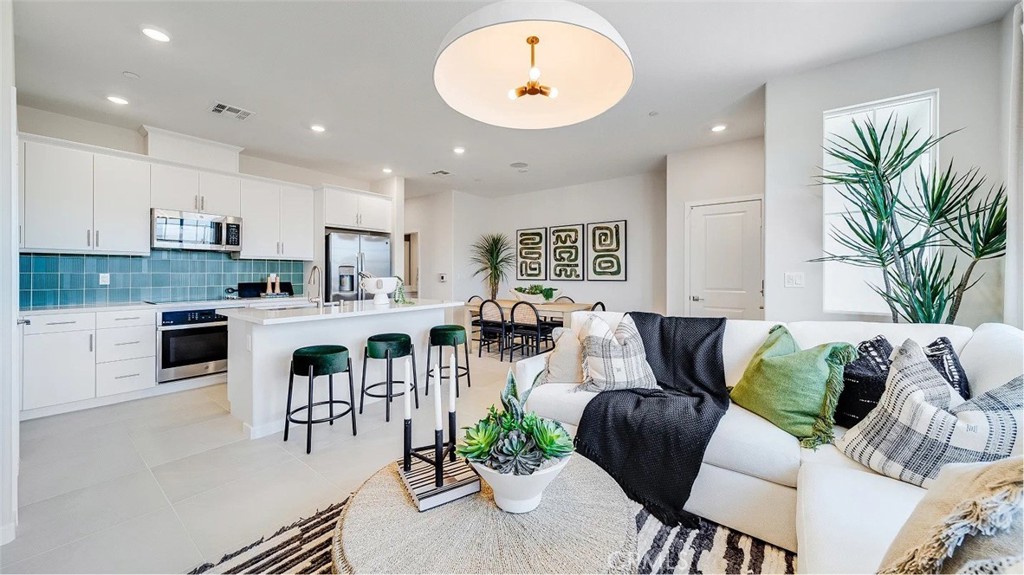 2571 Cloudview Privado Ontario, CA 91761 - Photo 1 of 19 a living room with furniture kitchen and a potted plant