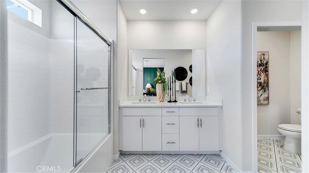 2571 Cloudview Privado Ontario, CA 91761 - Photo 12 of 19 a bathroom with a shower sink and mirror